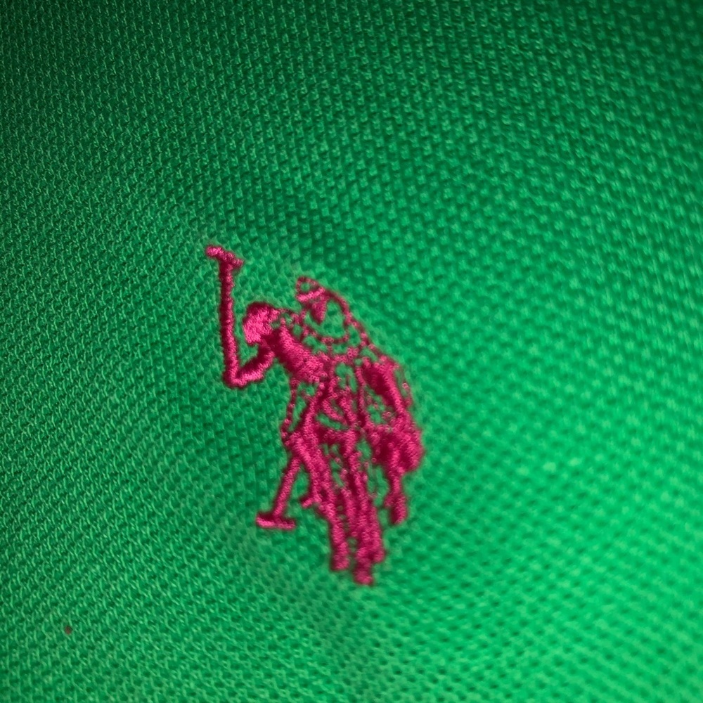 very cropped green polo shirt with pink detailing